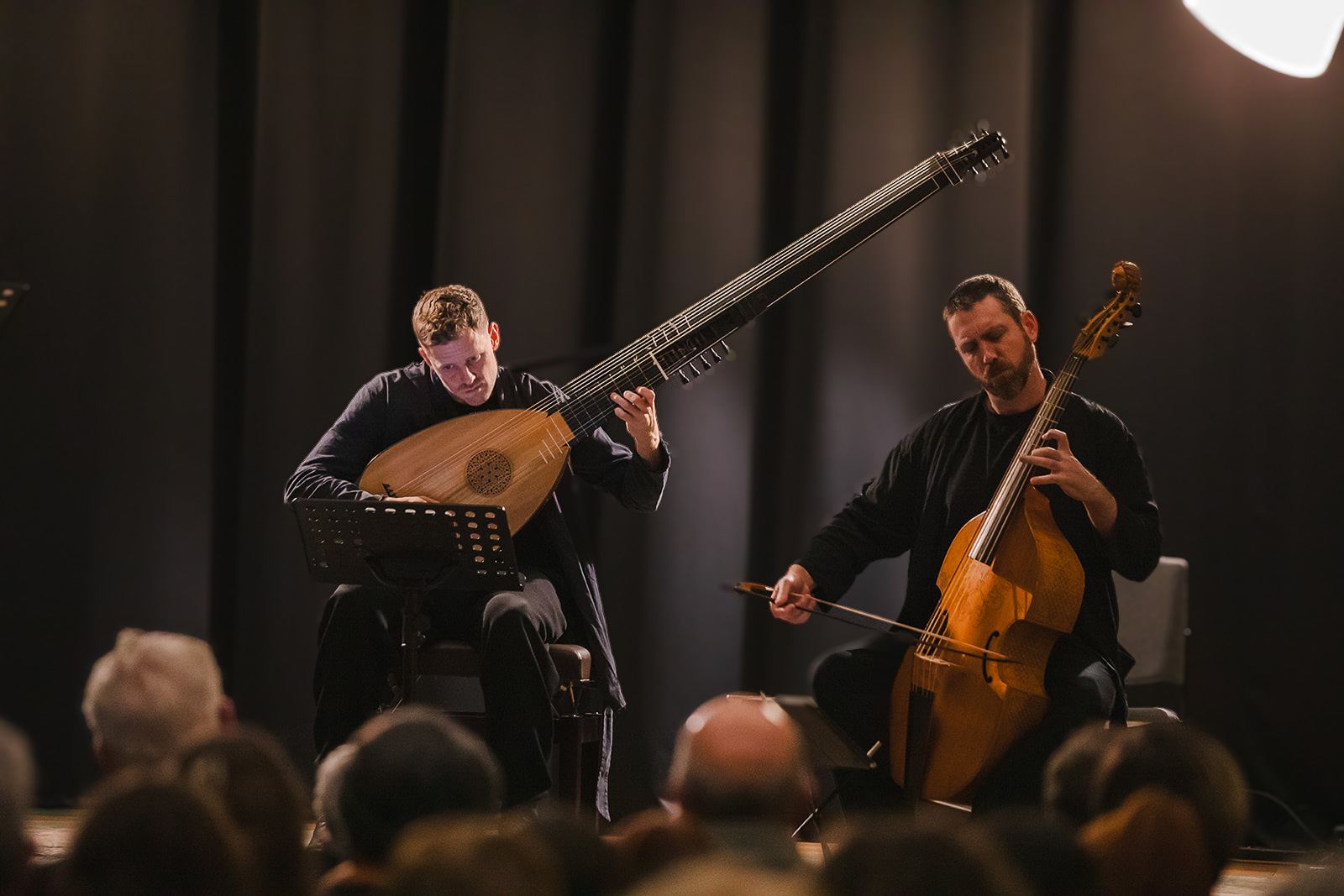 Lute and viola da gamba in performance, the audience in the foreground