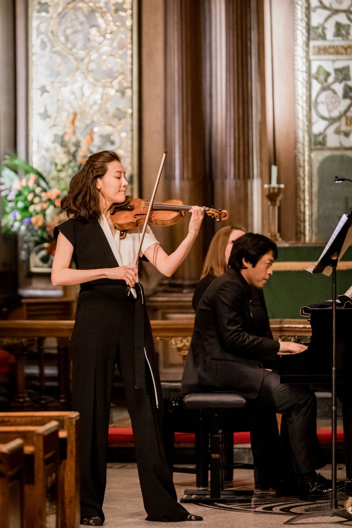 Violin and piano together under the church's tall windows