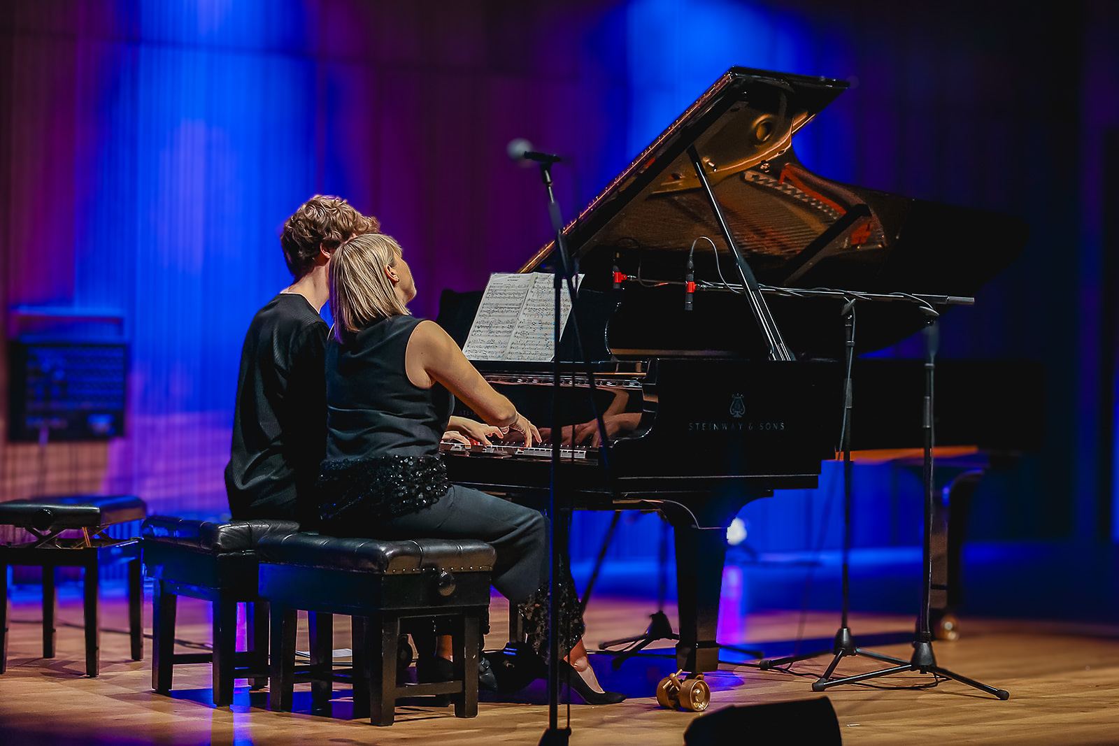 Backlit in blue at the piano