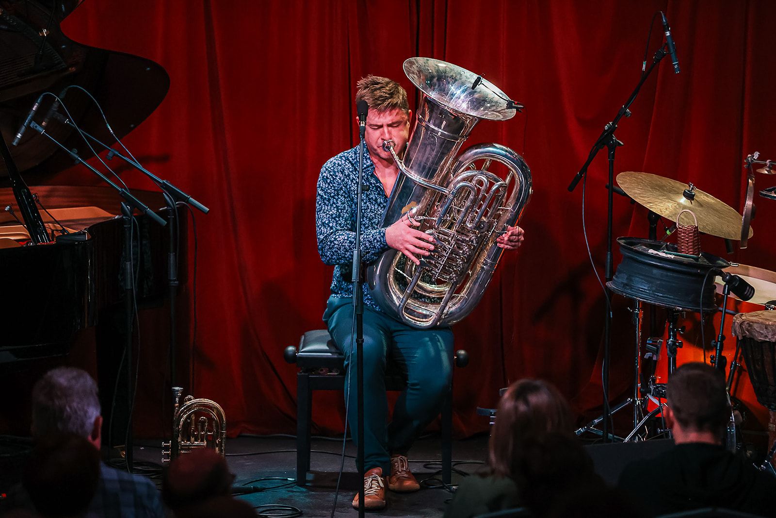 Daniel Herskedal's trio on stage at The Sugar Club, tuba in the foreground and red curtain behind