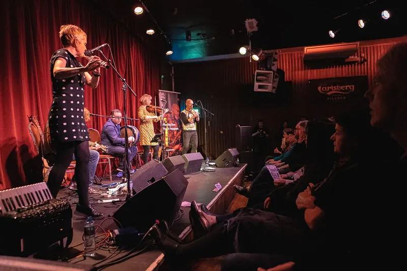 Flook and Patsy Reid across the stage of The Sugar Club, the audience in front