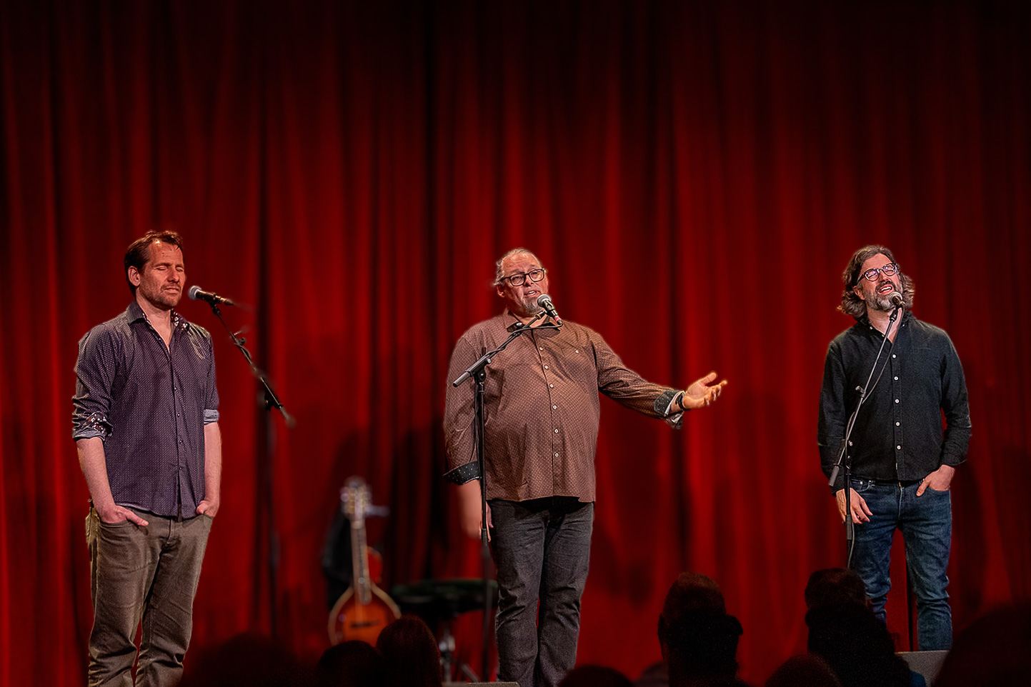 The three members of Genticorum standing together on stage