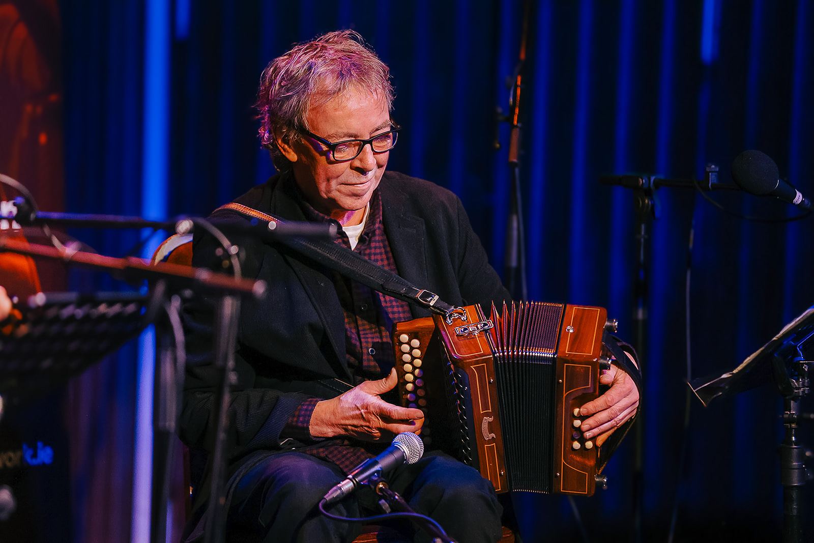 Dermot Byrne at the accordion in blue light