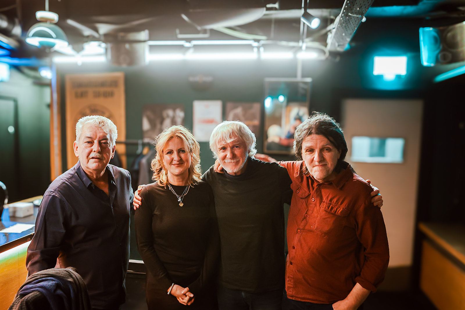 The four musicians together backstage