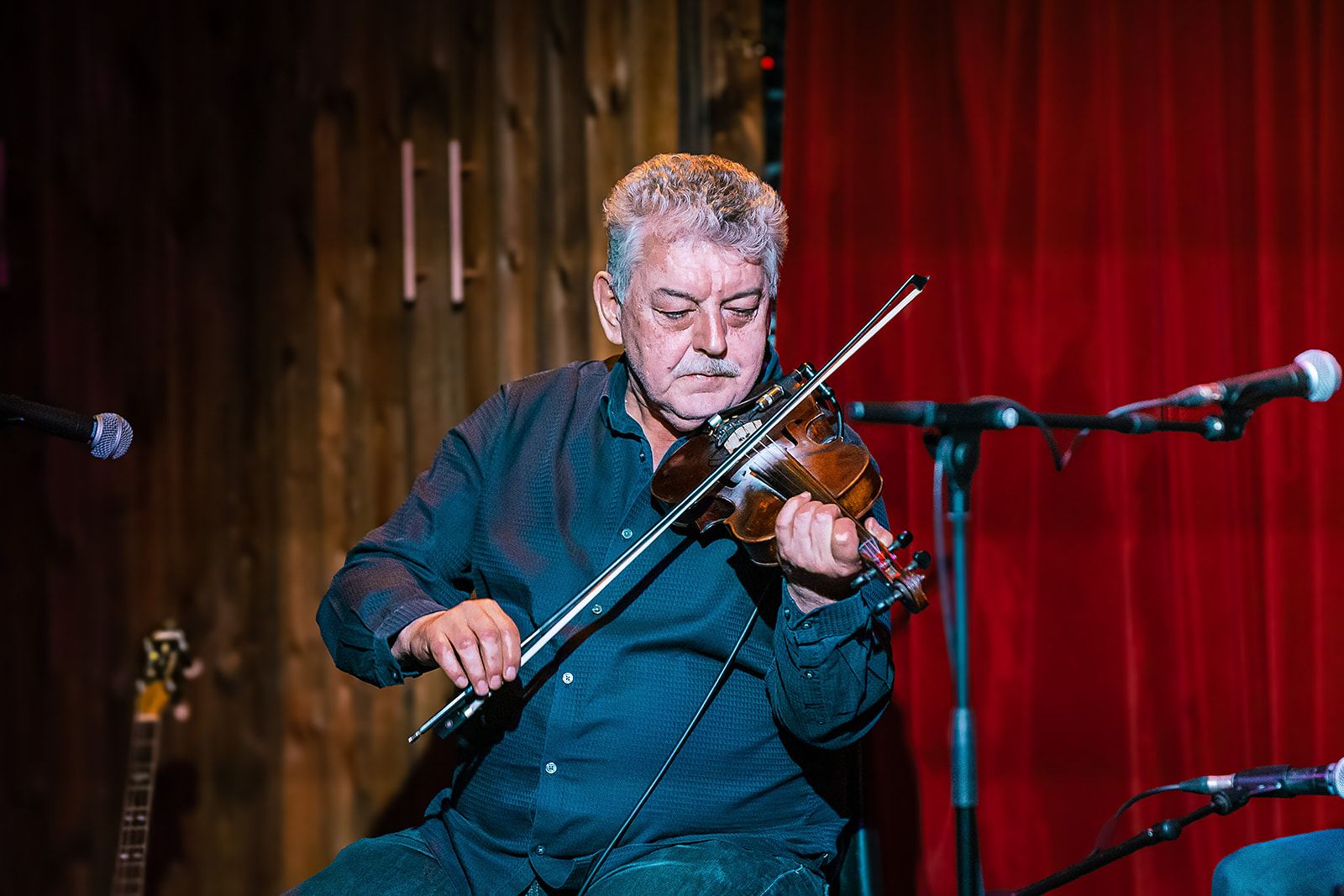 Playing fiddle under stage light