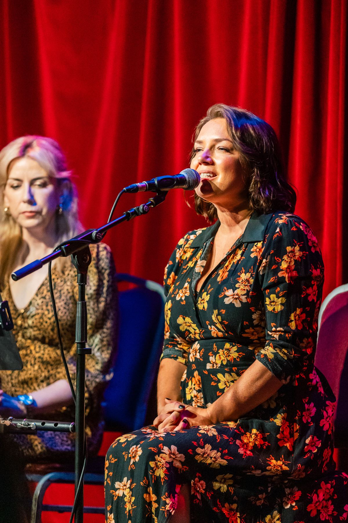 Muireann Nic Amhlaoibh singing, Pauline Scanlon listening beside her
