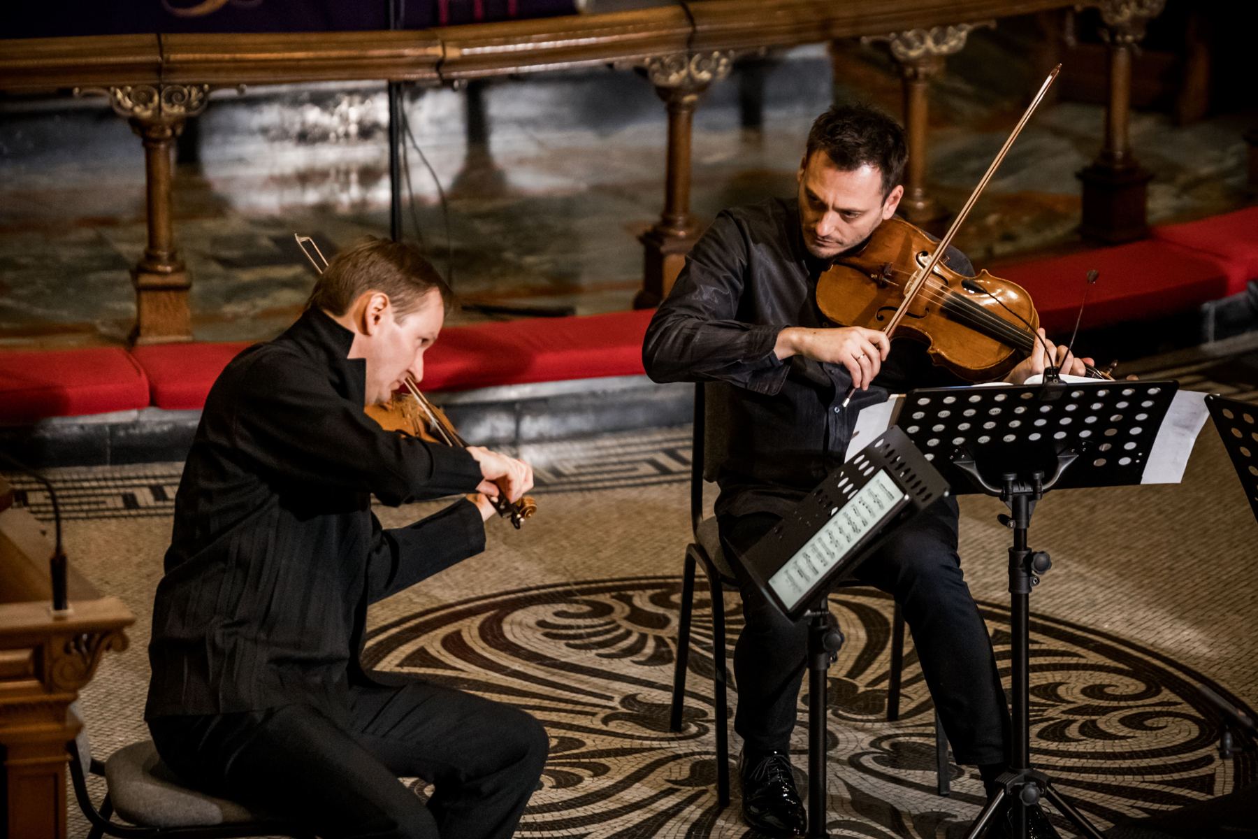 Maxim Rysanov and Nikita Boriso-Glebsky playing side by side over the patterned floor of the chancel
