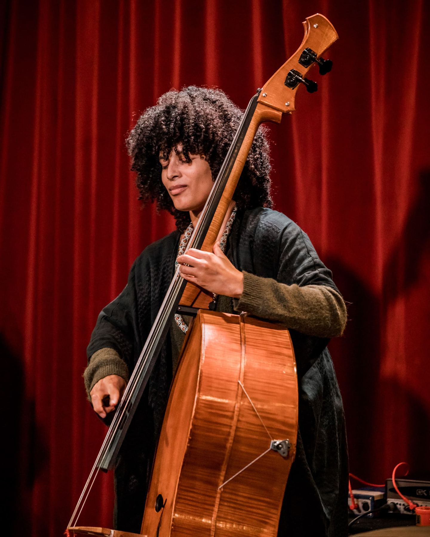 Sélène Saint-Aimé playing the double bass, eyes half closed